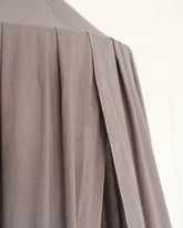 a close up of a person wearing a gray shirt